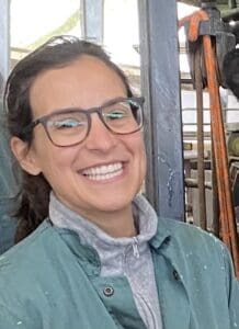Smiling woman with glasses in barn